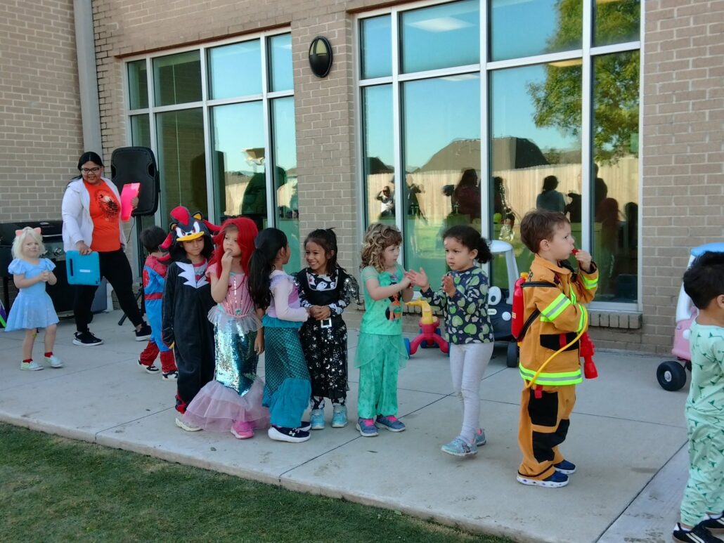 A photo of children lined up walking in halloween costumes outside of preschool and daycare Hebron 336