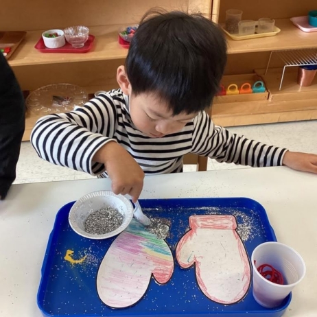 kid painting mittens at preschool and daycare at 335 Peter's Colony
