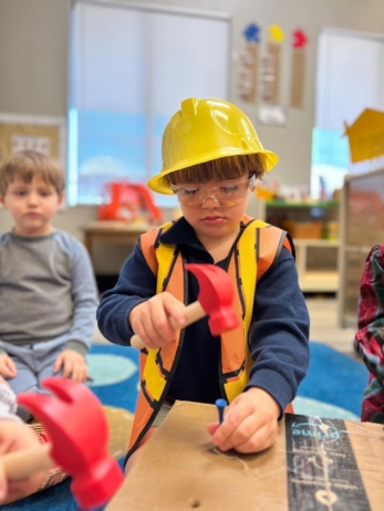 male child hands on engaging in learning at little big minds chandler