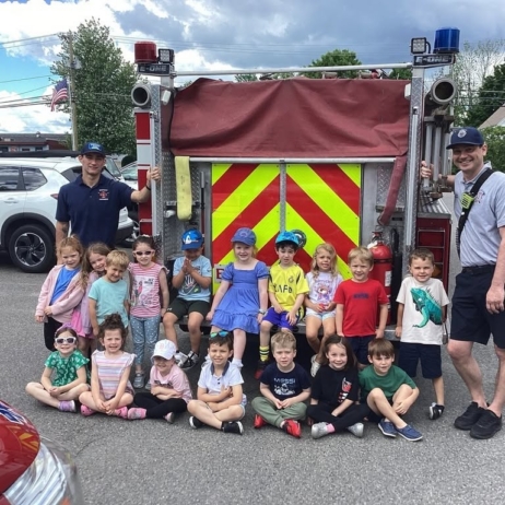 children smiling with firefighters learning at preschool and daycare at cadence academy preschool 450 whitman washington