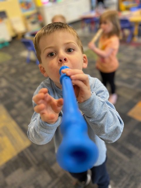 an image of a child playing a musical instrument