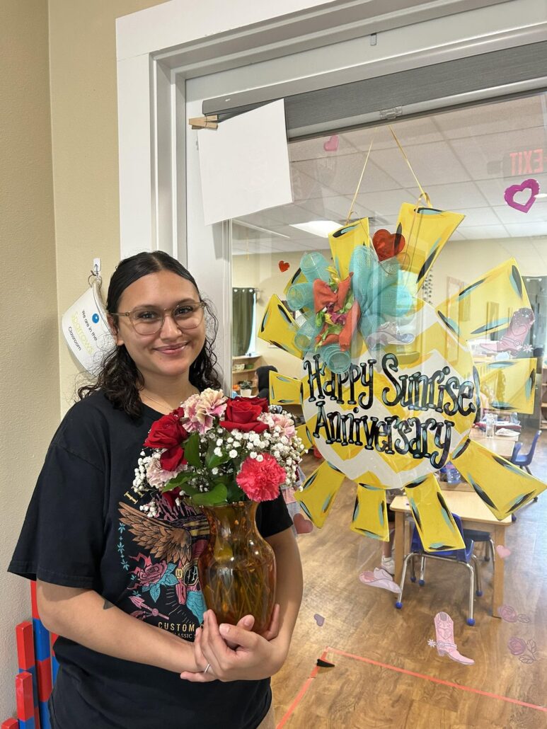teacher posing for preschool and daycare anniversary at 326 acl
