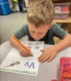 child learning how to write on homework at cadence academy preschool and daycare west o 510