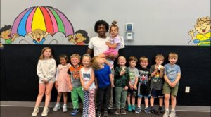children posing with summer camp teacher at cadence academy preschool and daycare west o 510