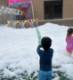 Child playing in foam party outside at cadence academy preschool west o 510