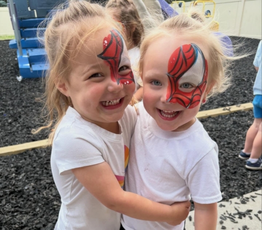 Children hugging and smiling together with spiderman face paint at the professors learning center daycare and preschool elkhorn NE 509