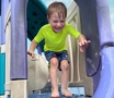 Child playing outside after water day on slide at the professors learning center daycare and preschool elkhorn NE 509