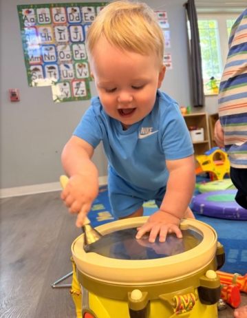 child playing with drum at the professors learning center daycare and preschool elkhorn NE 509