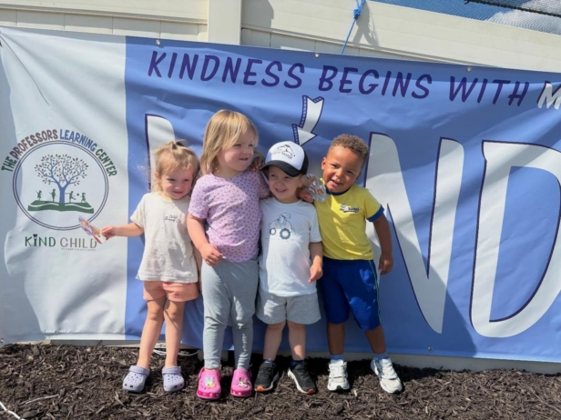 children smiling next to I am kind sign at the professors learning center daycare and preschool elkhorn NE 509