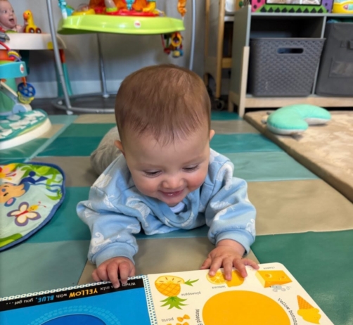 Infant with book at the professors learning center daycare and preschool elkhorn NE 509