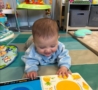 Infant with book at the professors learning center daycare and preschool elkhorn NE 509