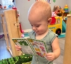 Infant holding book and learning to read at the professors learning center daycare and preschool elkhorn NE 509