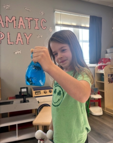 Girl holding sensory play toy at the professors learning center daycare and preschool elkhorn NE 509