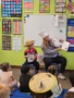 child interacting with adult reading to class at watch me grow germann
