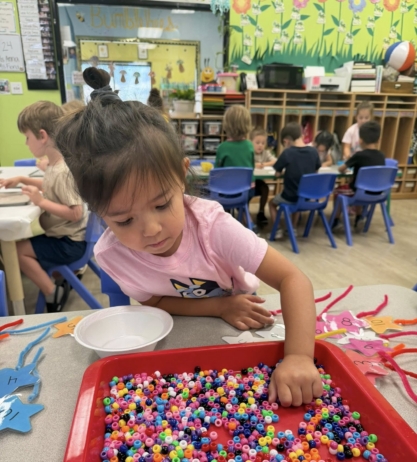 female child learning with hands on activity at watch me grow germann