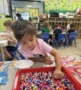 female child learning with hands on activity at watch me grow germann