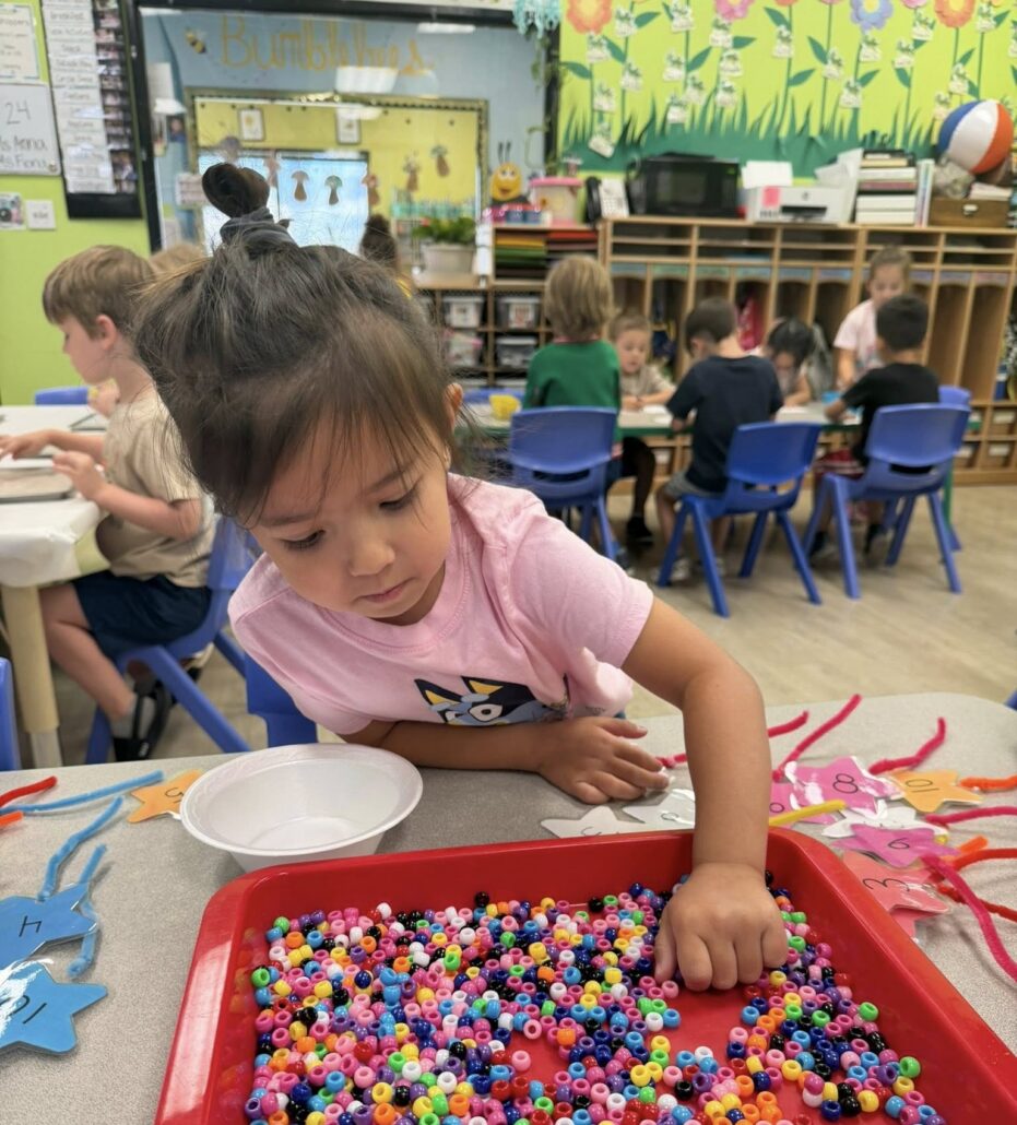 female child learning with hands on activity at watch me grow germann