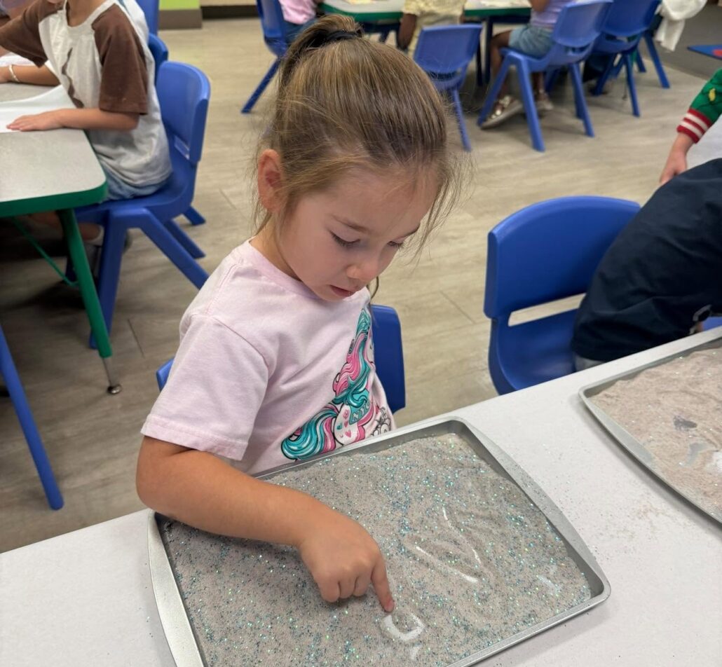 female child learning with hands on learning activity at watch me grow germann