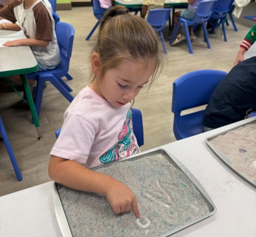 female child learning with hands on learning activity at watch me grow germann