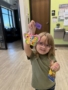 female child posing with arts and crafts hands on activity at watch me grow power