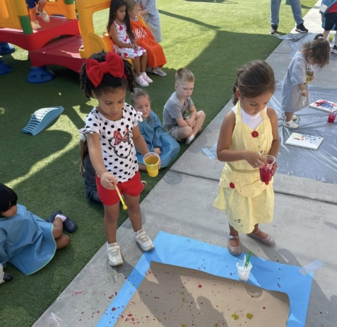 female children doing arts and crafts outside at watch me grow riggs