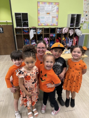 male and female children posing with teacher at watch me grow power