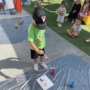 male child doing arts and crafts outside at watch me grow riggs