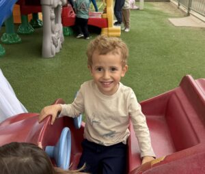 male child playing happy on playground at watch me grow germann