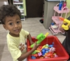 male child playing inside with toys learning at watch me grow riggs