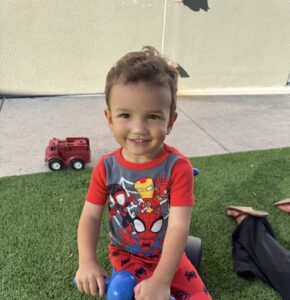 male child playing outside at watch me grow power