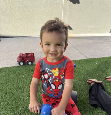 male child playing outside at watch me grow power