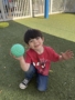male child playing outside smiling at watch me grow power