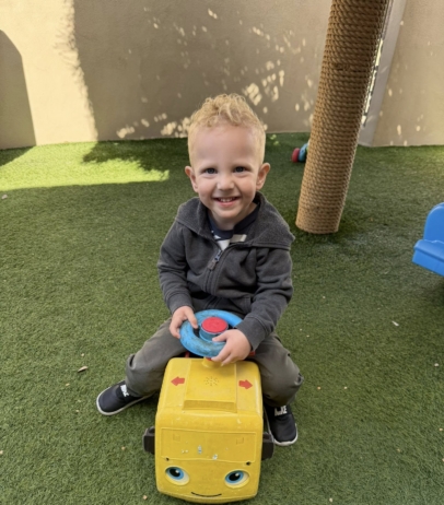 male child playing smiling on playground at watch me grow germann