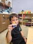 male child smiling with hands on craft activity at watch me grow power