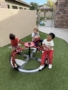 three male children playing outside on playground at watch me grow germann