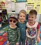 three male children smiling together at watch me grow power