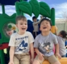 two male children laughing on playground at watch me grow riggs