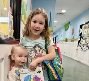 younger and older children smiling together at watch me grow germann