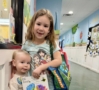 younger and older children smiling together at watch me grow germann