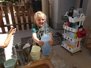 child engaged in a sensory water play activity at natural choice academy
