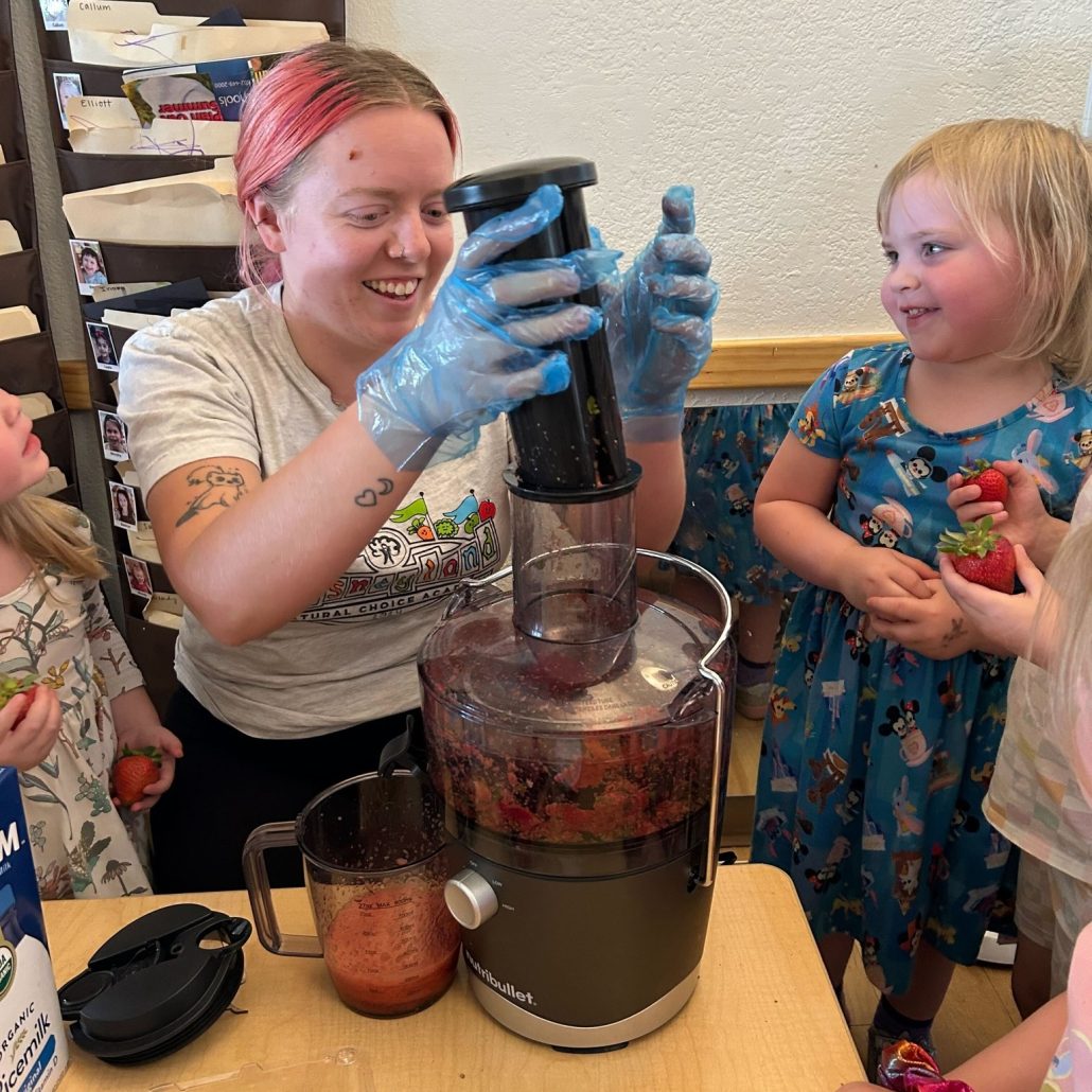 teacher guiding young children through a science activity at natural choice academy