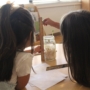 children participating in a hands-on classroom project with a teacher at natural choice academy