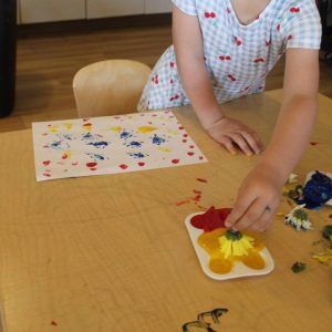 child participating in a fine motor and creative learning activity at natural choice academy