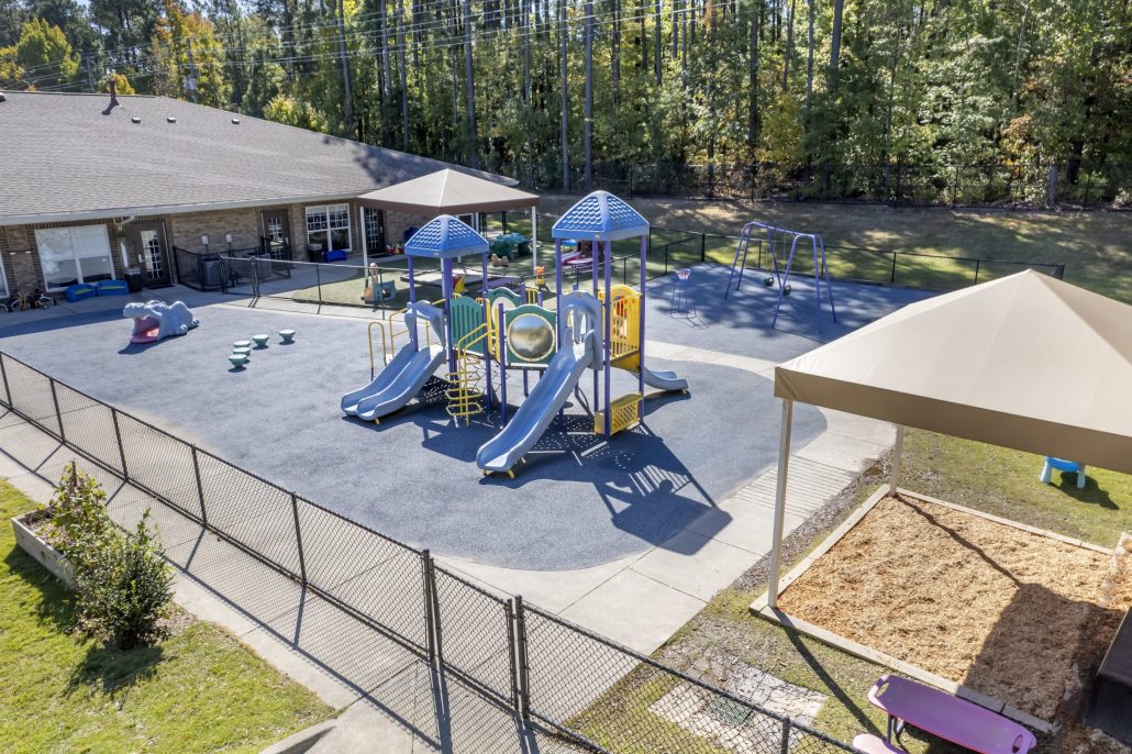 Cadence Acaemy Preschool in Brier Creek Playground 2 Slides and Other Activities Safely Enclosed In Back of Facility