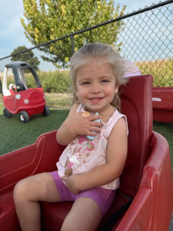Child smiling at camera in preschool classroom Generation Next Bondurant