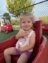 Child smiling at camera in preschool classroom Generation Next Bondurant