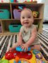 Baby smiling at camera in infant care classroom Generation Next Bondurant