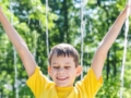 child in yellow shirt playing in the splash pad located at the daycare in greensboro north carolina