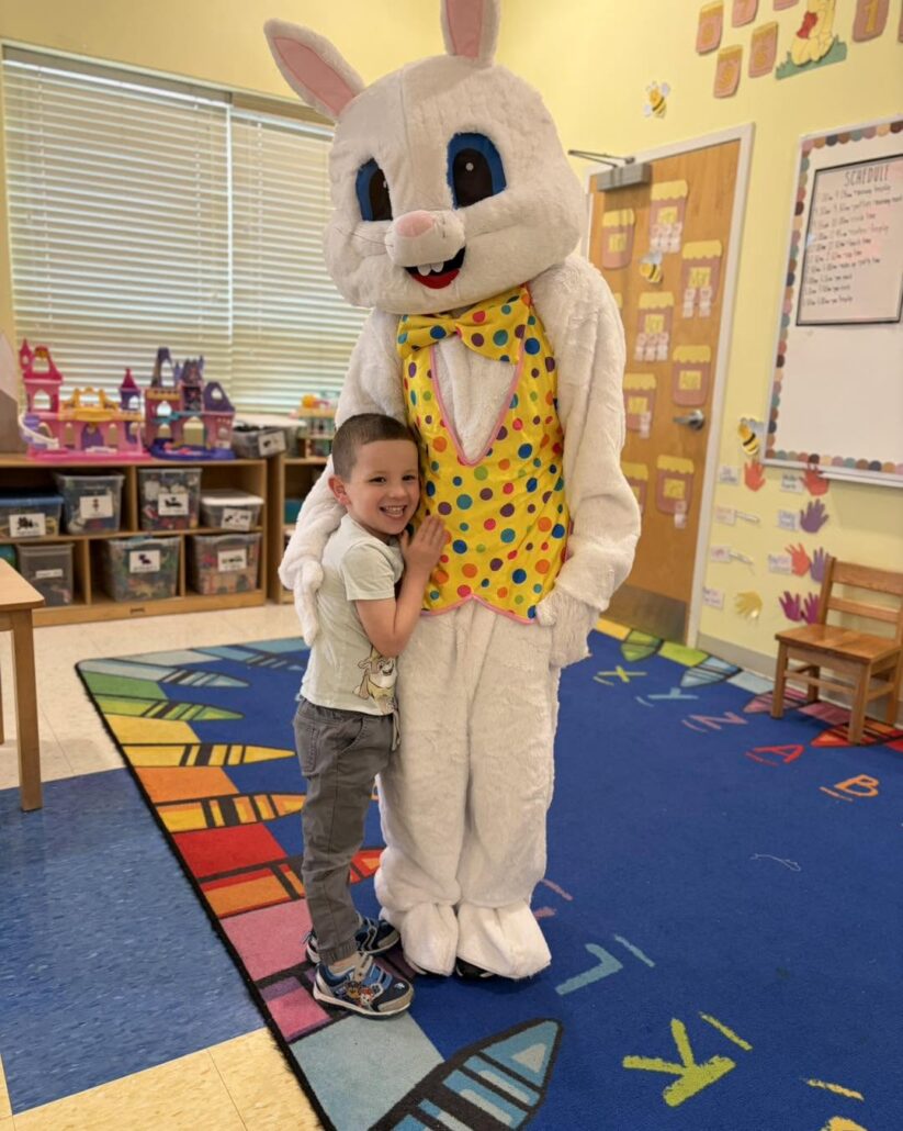 child hugging easter bunny in classroom at 463 precious